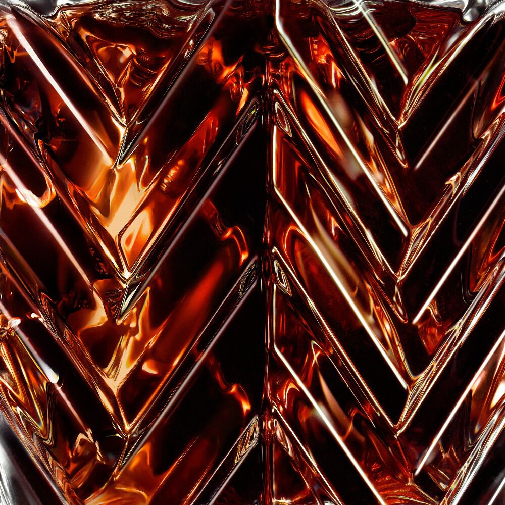 YSL LVDP Blouse Extrait de Parfum 50ml bottle, close-up on the elegant chevron glass pattern and amber liquid.