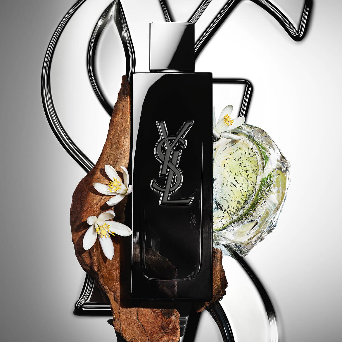 MYSLF Eau de Parfum bottle by YSL Beauty surrounded by fresh bergamot, orange blossom and woods.