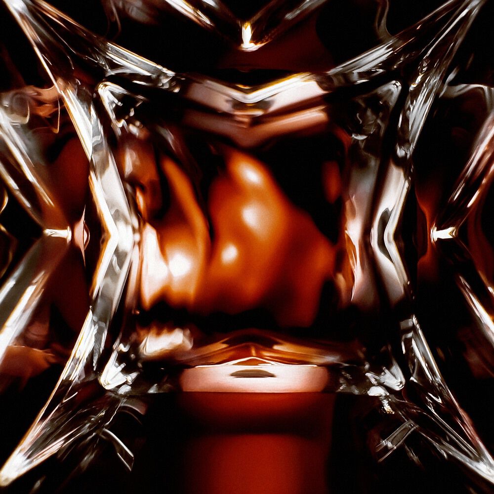 YSL LVDP Blouse Extrait de Parfum bottle, extreme close-up of the intricate glass design with luminous reflections.